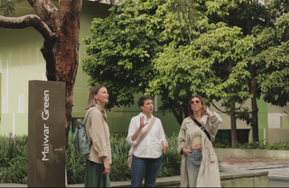 A Brisbane Unexpected guide showing two women something outside of GoMA and Queensland State Library.