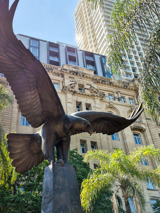 Close up of the top of the RAAF memorial in Queen's Gardens Brisbane CBD, featuring a bronze eagle with wings stretched-Brisbane Unexpected-Brisbane Tours-Must Do Brisbane